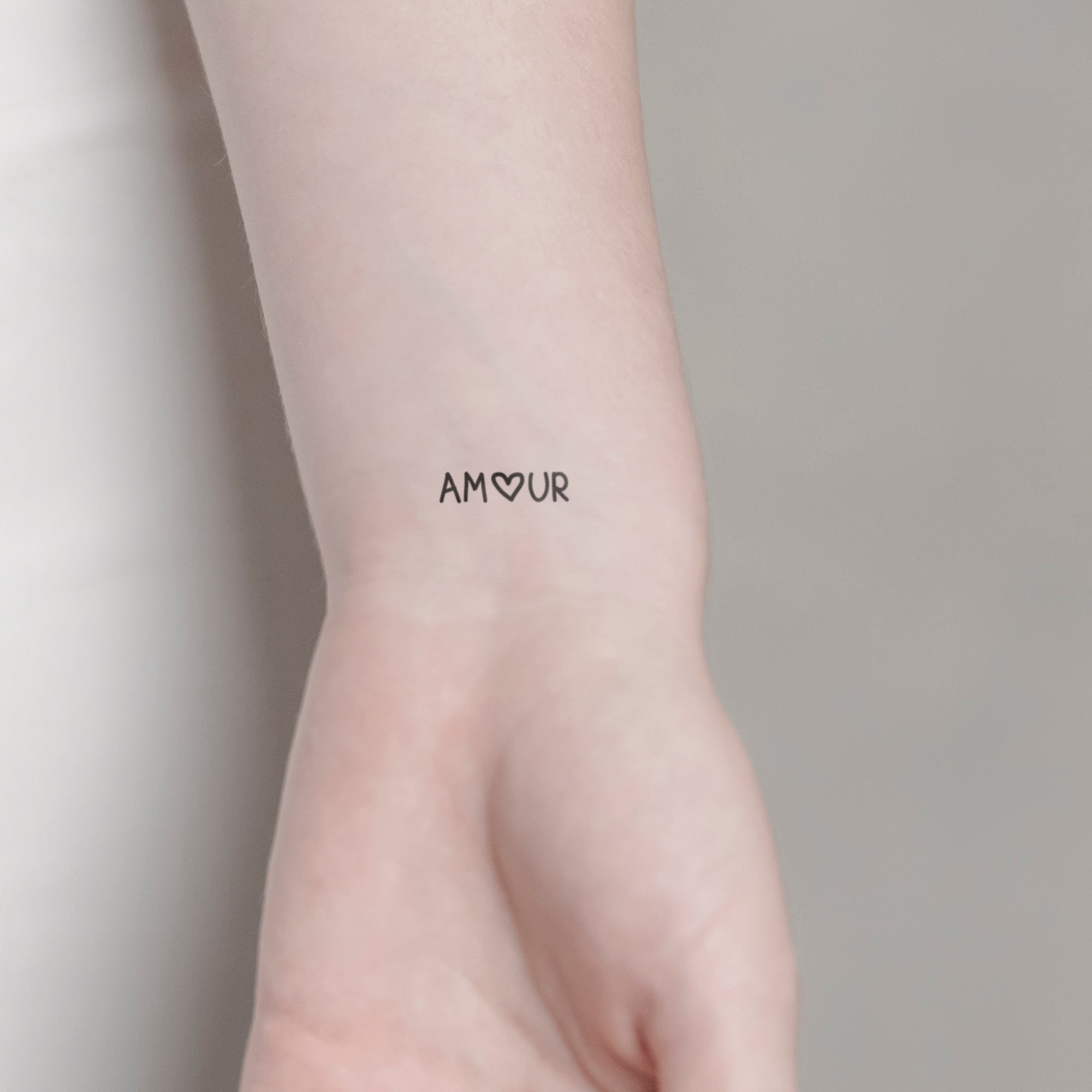 Schriftzug Tattoo AMOUR von minink, der Marke für temporäre Tattoos.