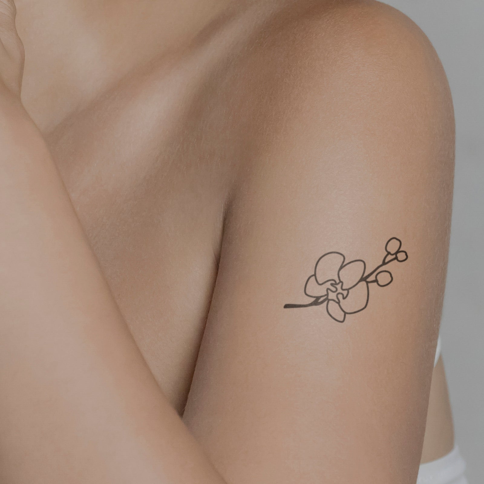 Realistic Orchid Flower Tattoo Design on Minimalist Branch | MUSE AI